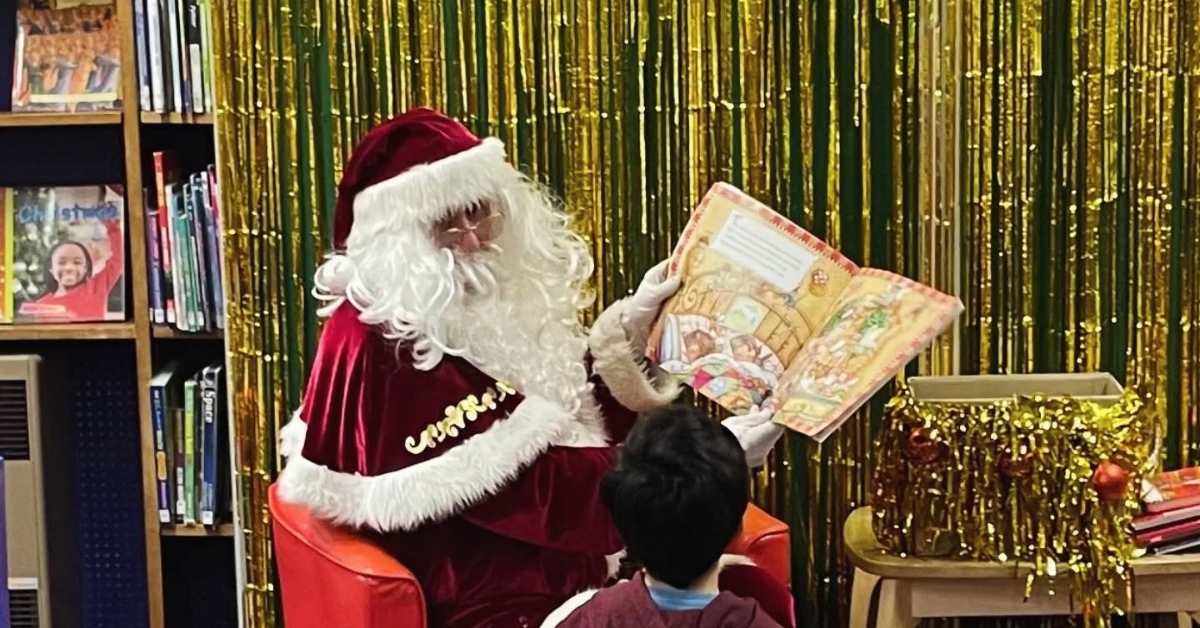 Santa reading a story to children at St Austell Library
