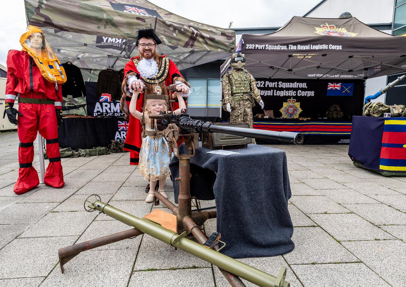 The Mayor and his child pose with an army replica