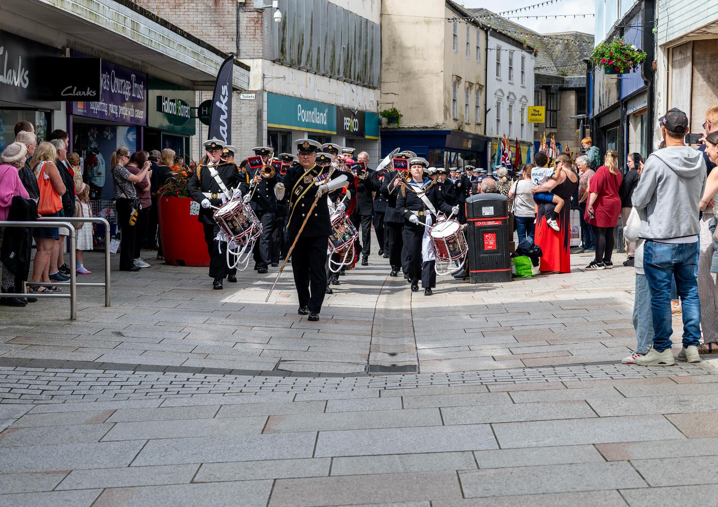 The parade marches through fore street