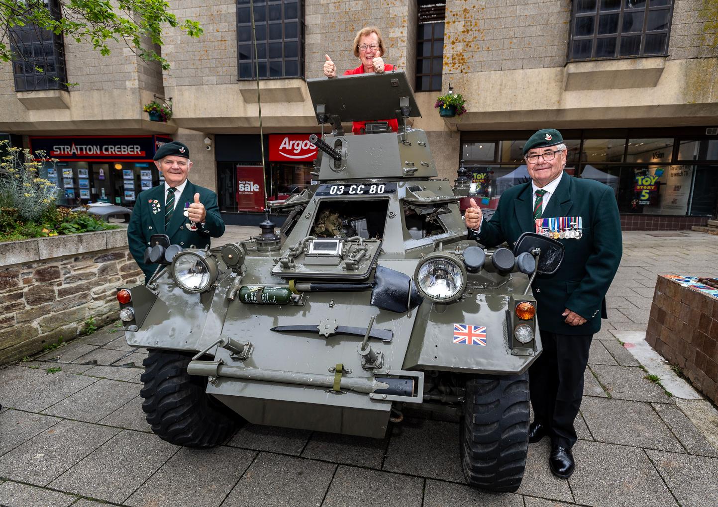 Officials pose with a tank