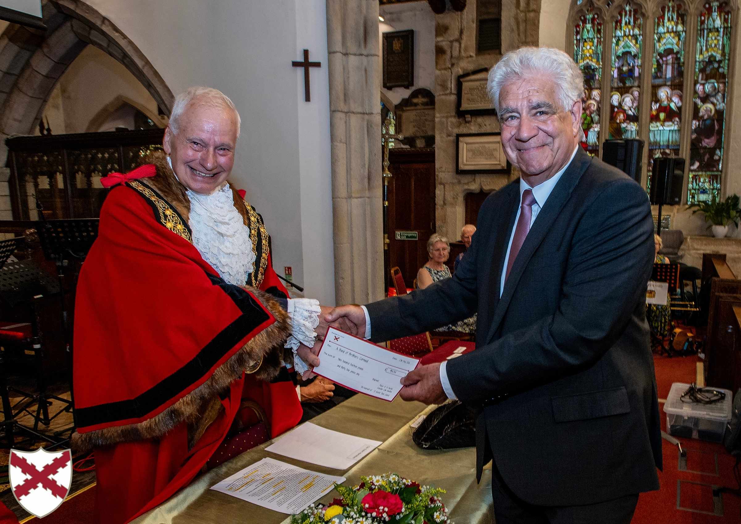 Outgoing Mayor Colin Hamilton hands a cheque to a representative from Cornwall Band of Brothers
