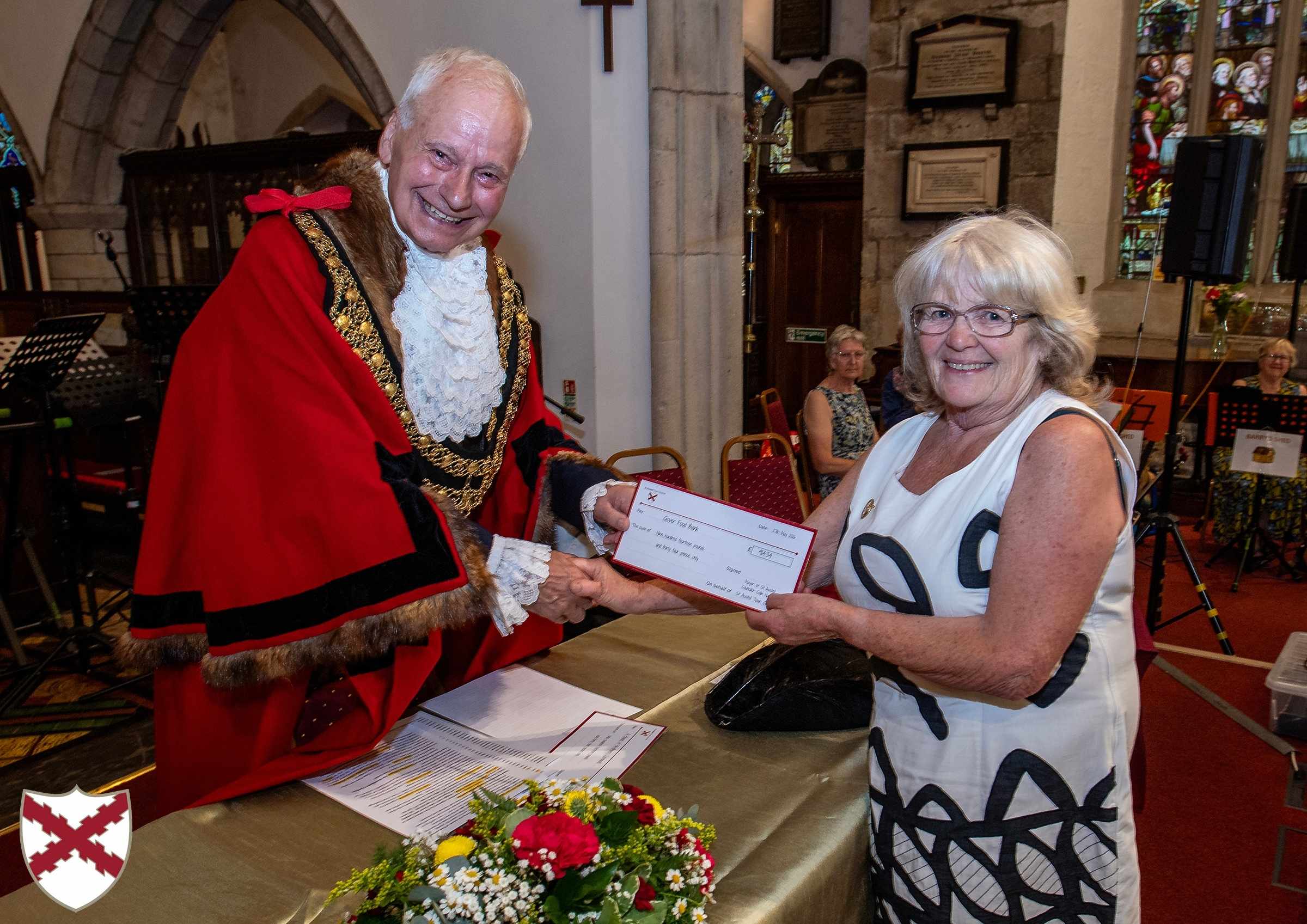 Outgoing Mayor Colin Hamilton hands a cheque to Sandra Heyward of Gover Community Larder
