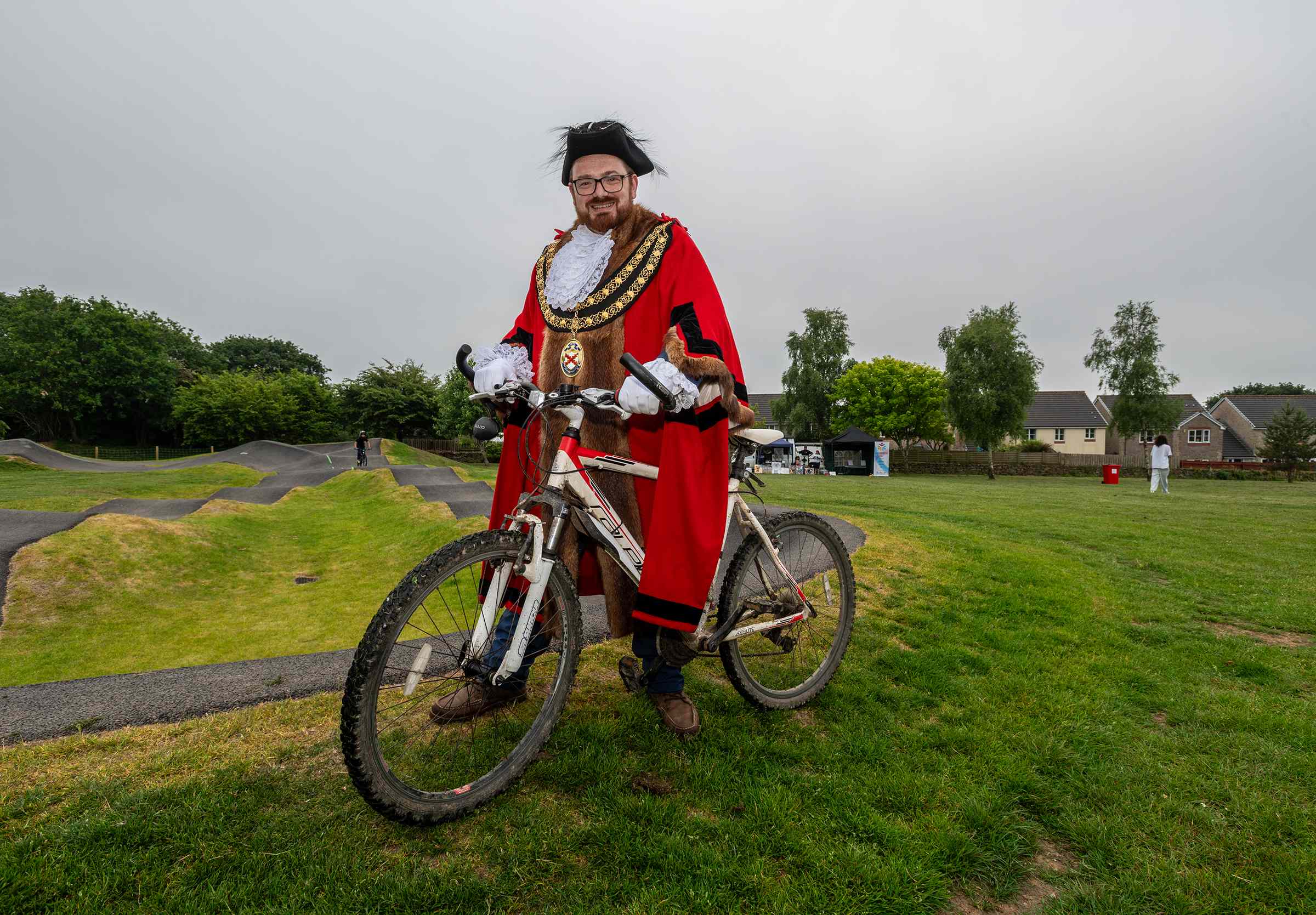 Cllr Ethan Stephens poses with a bike next to the pump track